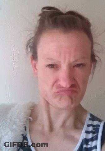 Woman Making Funny Face In Bun And Striped Shirt GIF