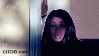 Woman Making Funny Face In Front Of Bar With Bottles GIF
