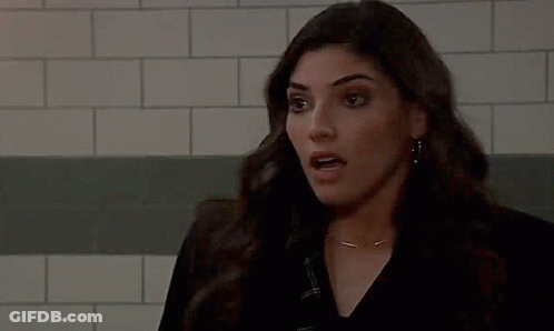 Woman Making Funny Face In Front Of Brick Wall GIF