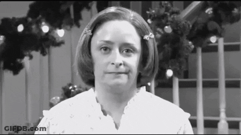 Woman Making Funny Face In Front Of Christmas Tree GIF