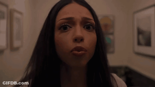 Woman Making Funny Face In Front Of Picture Wall GIF