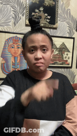 Woman Making Funny Face In Front Of Pyramid GIF
