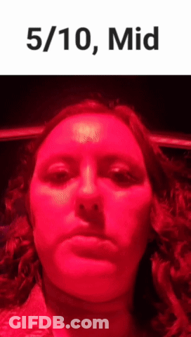 Woman Making Funny Face In Front Of Red Light GIF