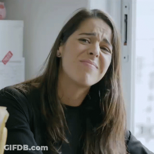 Woman Making Funny Face In Front Of Refrigerator With Sticker GIF