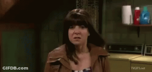 Woman Making Funny Face In Front Of Washing Machine GIF