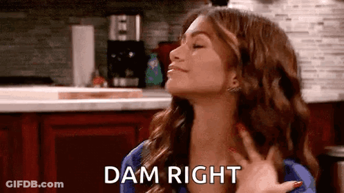 Woman Making Funny Face In Kitchen Holding Hand Saying Dam Right GIF