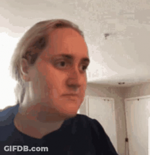 Woman Making Funny Face In Living Room GIF
