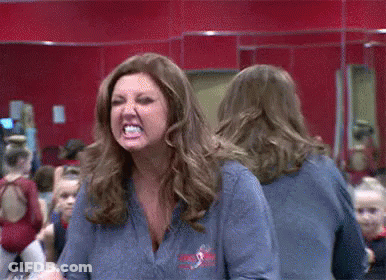 Woman Making Funny Face In Mirror GIF