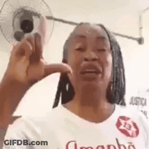 Woman Making Funny Face In White Shirt With Fan GIF