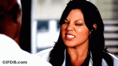 Woman Making Funny Face Talking To Man In Lab Coat GIF
