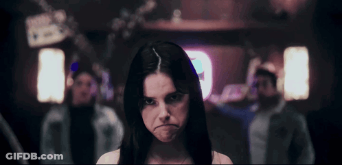 Woman Making Funny Face With A Sign GIF