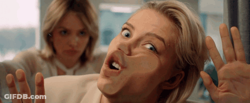 Woman Making Funny Face With Another Behind Her GIF