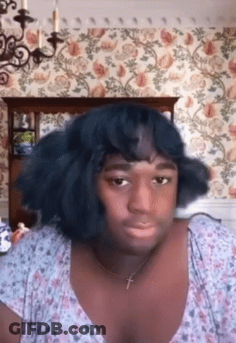 Woman Making Funny Face With Cross Necklace GIF