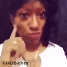 Woman Making Funny Face With Finger To Ear GIF