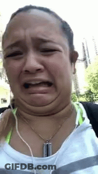 Woman Making Funny Face With Headphones GIF