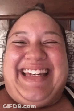 Woman Making Funny Face With Mouth Open On Bed GIF