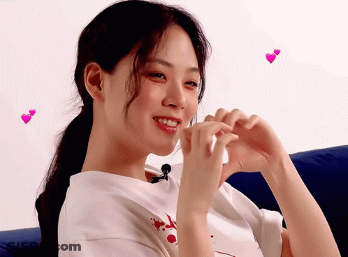 Woman Making Heart With Hands And Flying Hearts GIF
