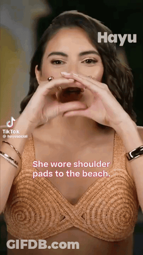 Woman Making Heart With Hands She Wore Shoulder Pads To The Beach GIF