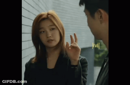 Woman Making OK Sign Next To Man GIF