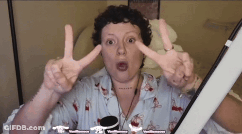Woman Making Peace Sign In Front Of Vanillasauce Screen GIF