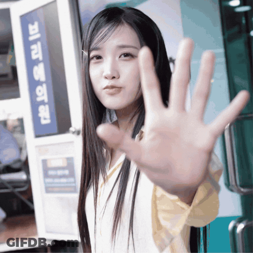 Woman Making Stop Sign In Front Of Korean Sign GIF