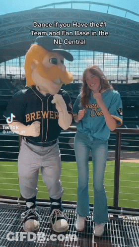 Woman Next To Brewers Mascot On Balcony GIF