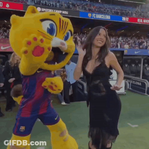 Woman Next To Cat Mascot In Front Of FC Barcelona Banner GIF
