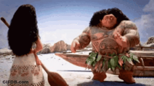 Woman Next To Man In Costume On Beach GIF