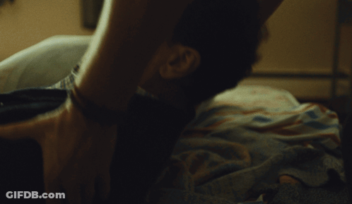 Woman Next To Man On Bed With Love On Wall GIF