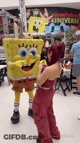 Woman Next To Spongebob Mascot Nickelodeon Universe Sign GIF