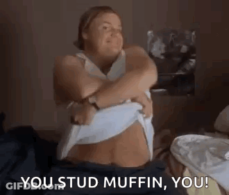 Woman On Bed Taking Off Shirt Saying You Stud Muffin GIF