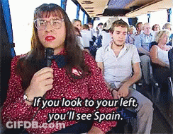 Woman On Bus Talking Into Microphone Saying If You Look To Your Left You'll See Spain GIF