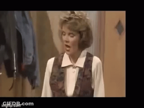 Woman On Couch Holding Bag Saying A GIF