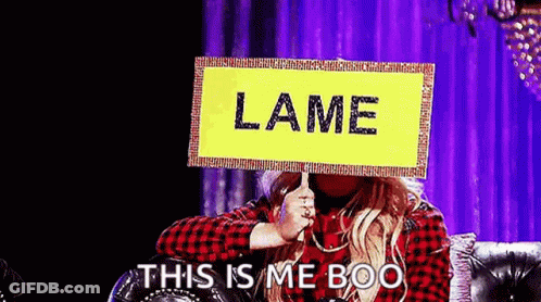 Woman On Couch Holding Lame Sign GIF