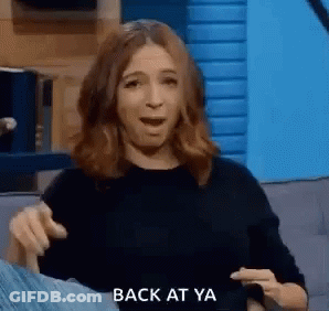 Woman On Couch Making Funny Face Pointing GIF