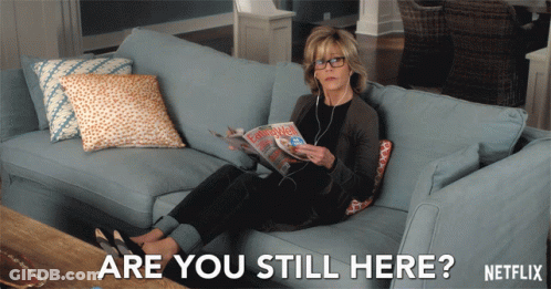 Woman On Couch Reading Magazine Saying Are You Still Here GIF