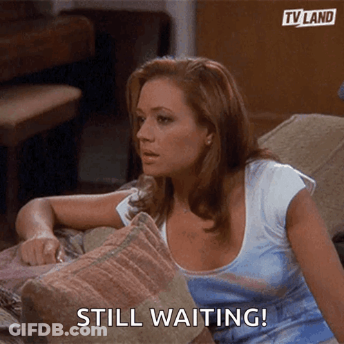Woman On Couch Saying Still Waiting GIF