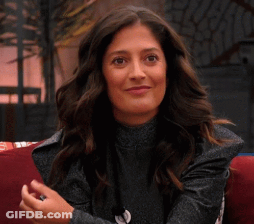 Woman On Couch Smiling Waving Hands GIF