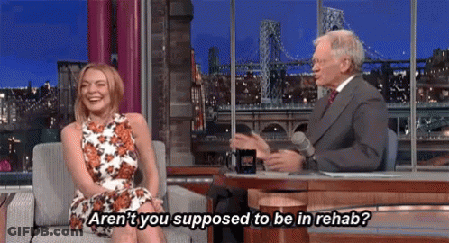 Woman On Couch Talking To Man In Suit GIF