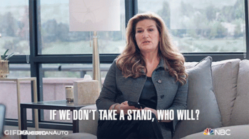 Woman On Couch With Caption If We Don't Take A Stand Who Will GIF