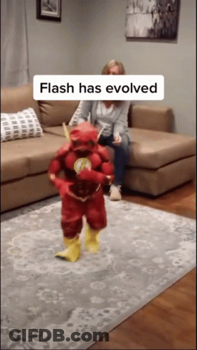 Woman On Couch With Child In Flash Costume GIF