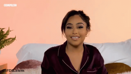Woman On Couch With Cosmopolitan Logo GIF