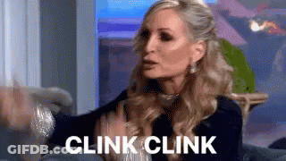 Woman On Couch With Hands Outstretched Saying Clink Clink GIF
