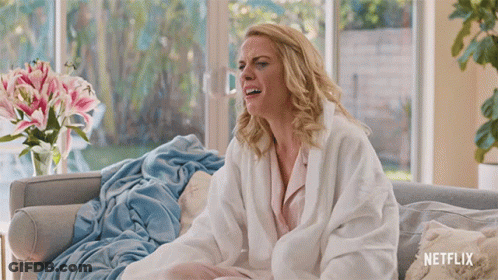 Woman On Couch With Netflix Blanket GIF