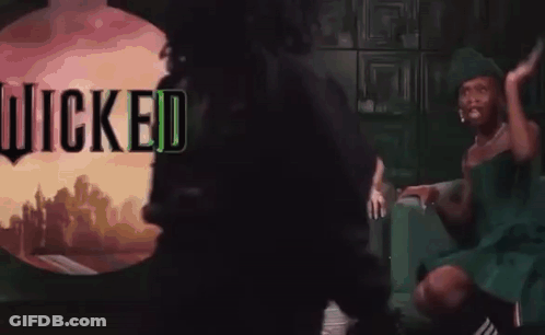 Woman On Couch With Wicked Sign GIF