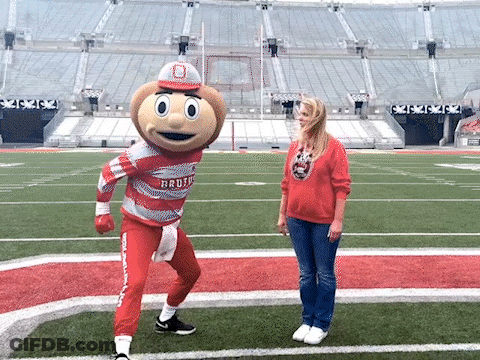 Woman On Football Field With Buckeyes Mascot GIF