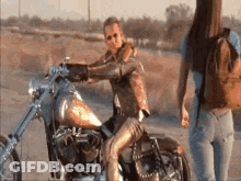 Woman On Motorcycle And Woman Standing GIF
