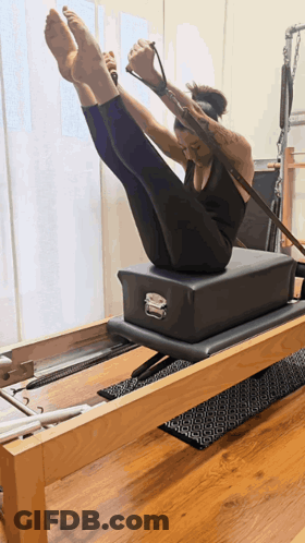 Woman On Pilates Machine Legs Up GIF
