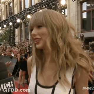 Woman On Red Carpet In Front Of Crowd Saying MMV GIF