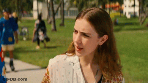 Woman On Sidewalk In Park With Man In Blue Shirt GIF